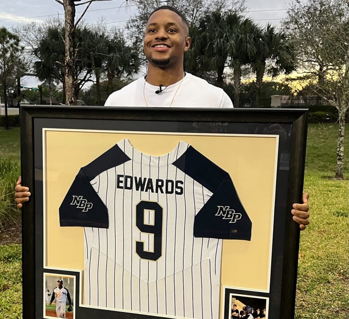Miami Marlins' infielder Xavier Edwards displays his No. 9 North Broward Prep Jersey, retired by his high school.